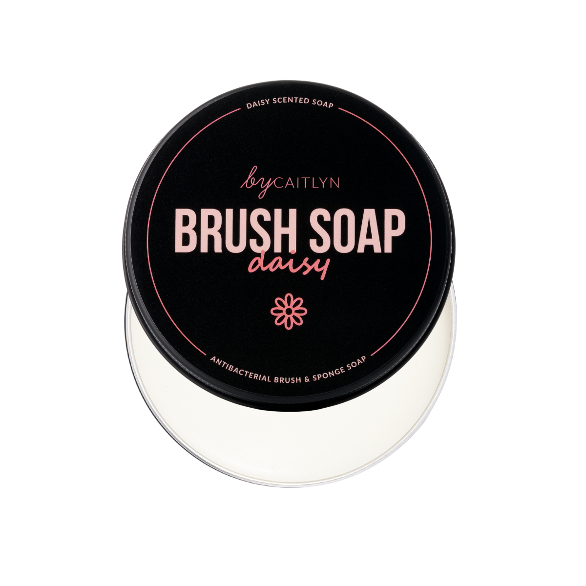Container of brush soap with a black lid featuring pink text on a white background