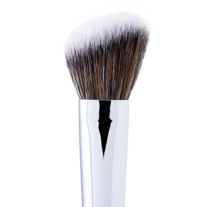 A close-up of an angled cheek brush with a fluffy, dome-shaped head made of synthetic bristles, and a silver handle.