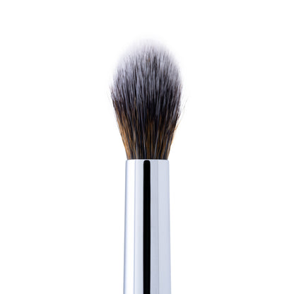 A close-up of a blending brush with soft, tapered bristles and a silver handle.